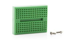 A green plastic case with holes and screws.