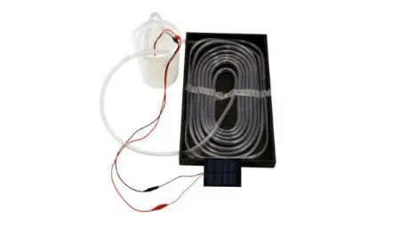 A black box with wires and a white tube