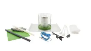 A table with various items on it including scissors, wire mesh and a spool of thread.