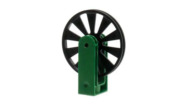 A green and black plastic object with a black wheel.