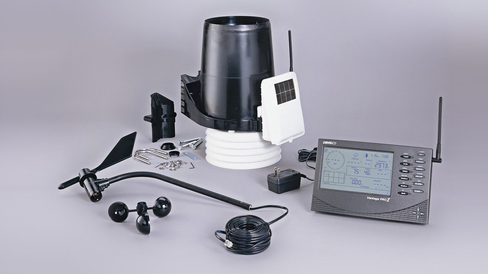 A table with various items including a radio, headphones and a monitor.