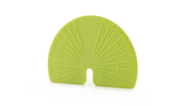 A green plastic fan shaped object sitting on top of a table.