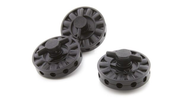 A group of four black plastic knobs.