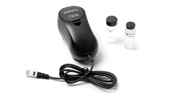 A black electric device with two bottles and a cord.