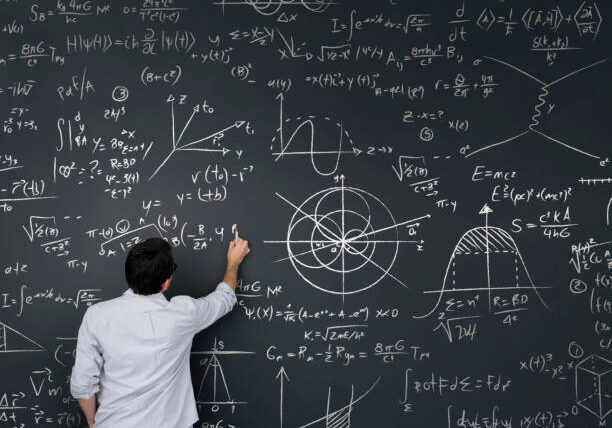 Physics teacher writing math equations on a blackboard â complex mathematics concepts